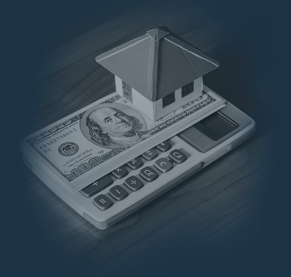2222p1aper-houses-money-and-calculator-stands-over-a-wooden-background